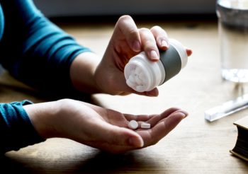 Woman taking medicine pills supplement