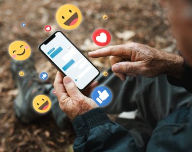 Senior man receiving positive reactions from social media